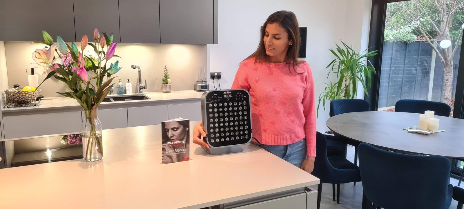 Total Spectrum MINI red light therapy device placed on a kitchen island in a home environment